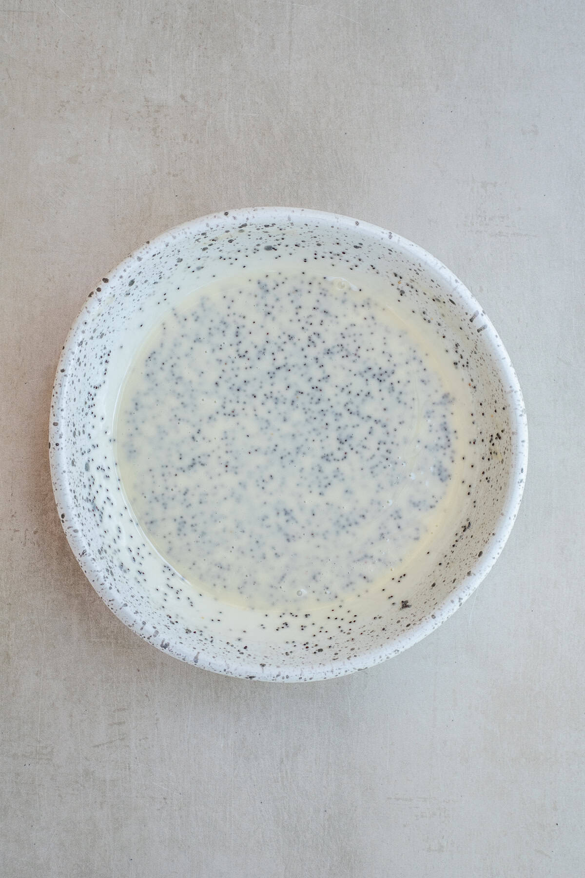 Creamy Poppy Seed Dressing for Fruit and Spinach Salads The poppy seed dressing in a bowl mixed together.