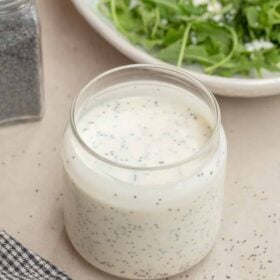 A jar with the creamy poppy seed dressing.