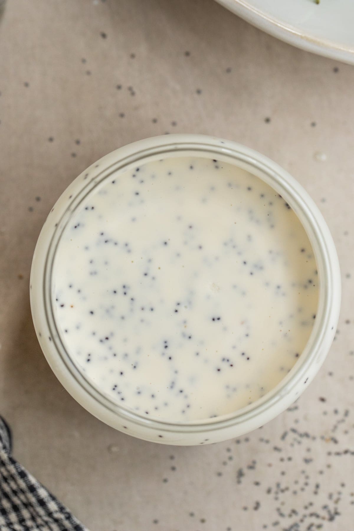 Better Than Store-Bought Poppy Seed Dressing A mason jar with the creamy poppy seed dressing.