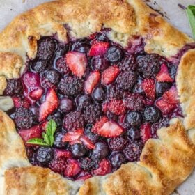 A mixed berry galette garnished with fresh mint.