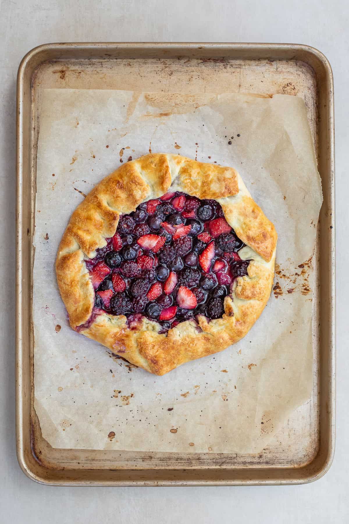 Homemade Berry Galette Recipe with Fresh Fruit Filling The baked berry galette on a sheet pan.