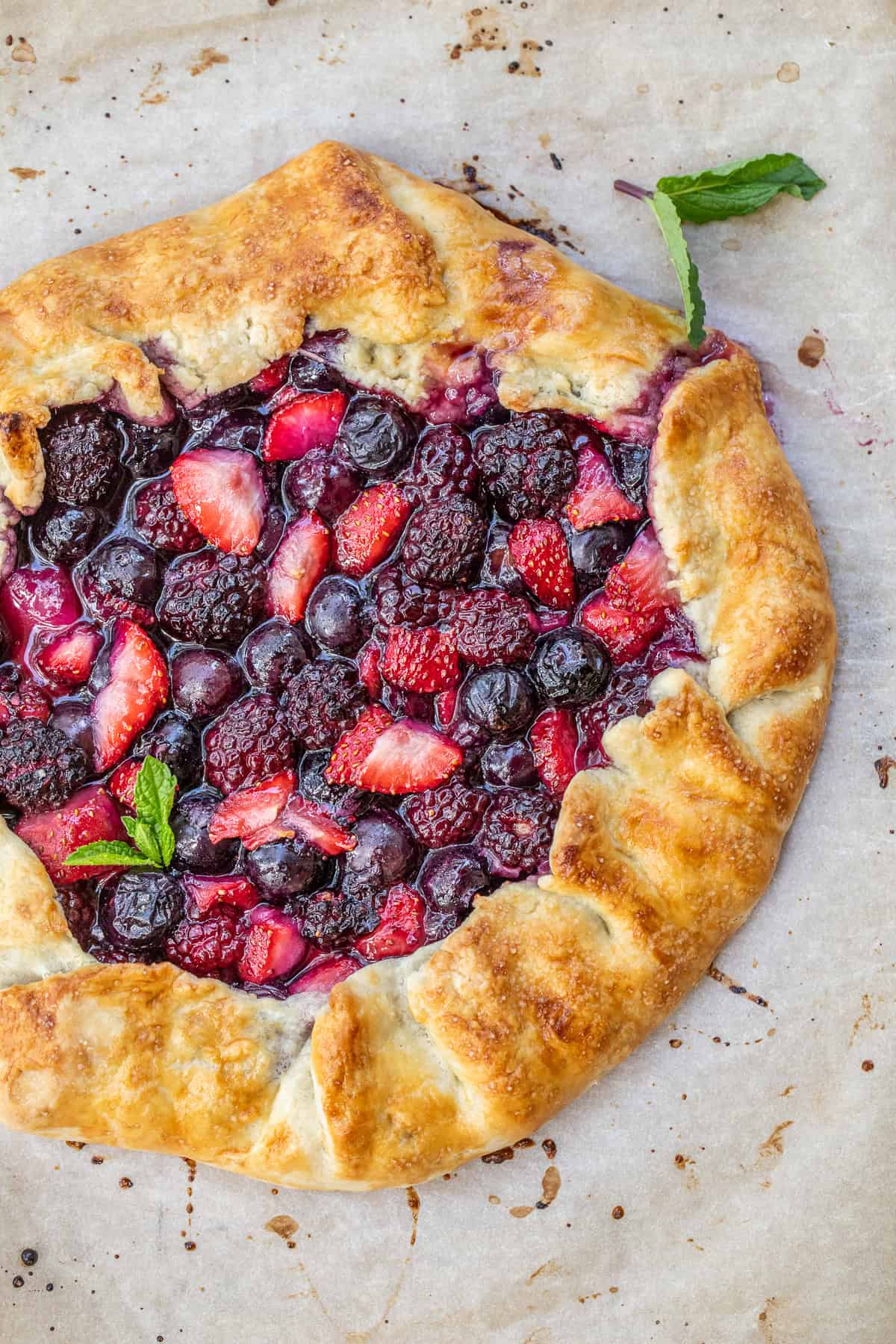 Rustic Mixed Berry Galette Made with Fresh Summer Berries A golden brown galette, loaded with a mixed berry filling.