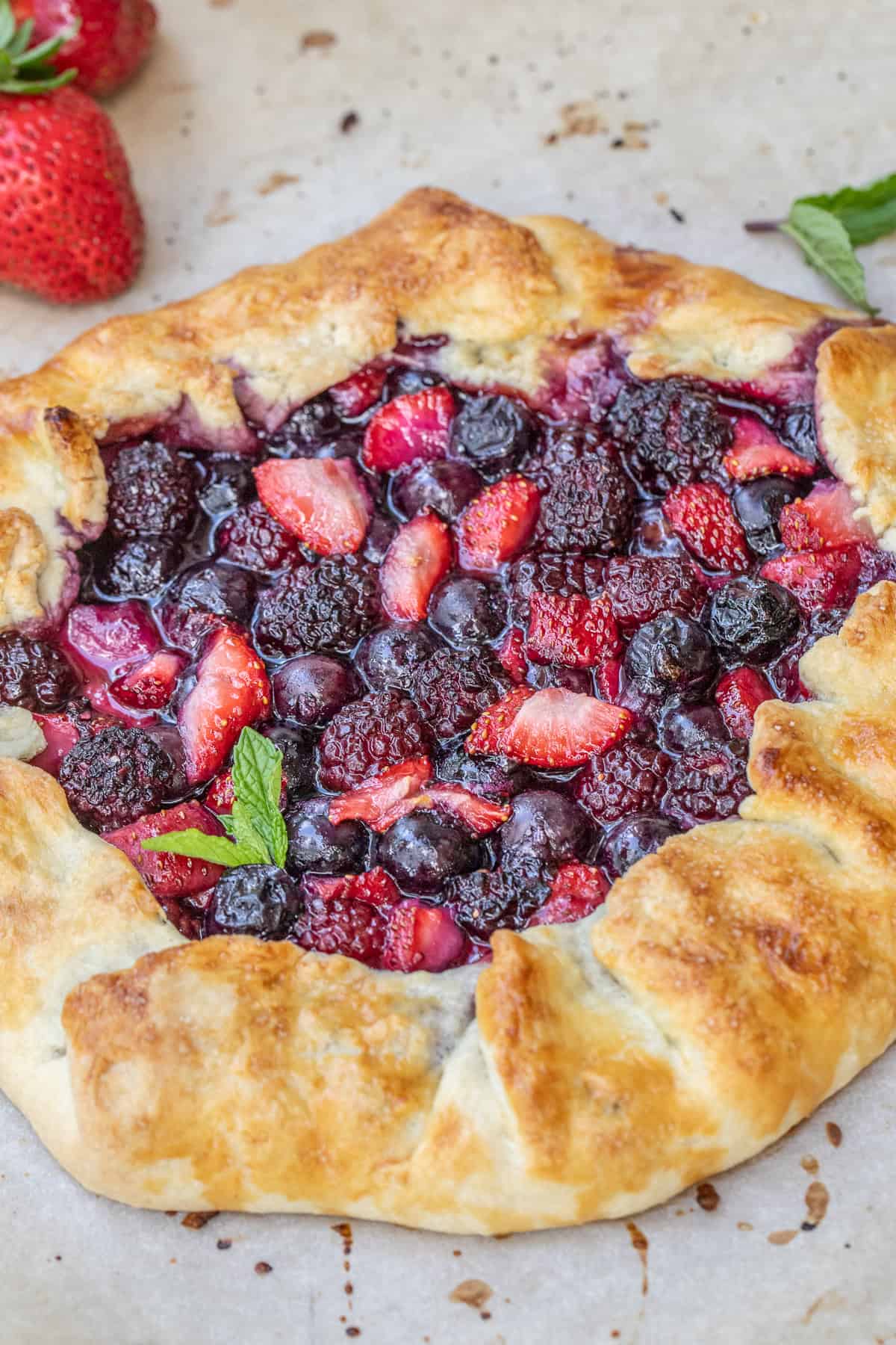 Simple Mixed Berry Galette with Fresh or Frozen Berries A baked mixed berry galette, topped with fresh mint.