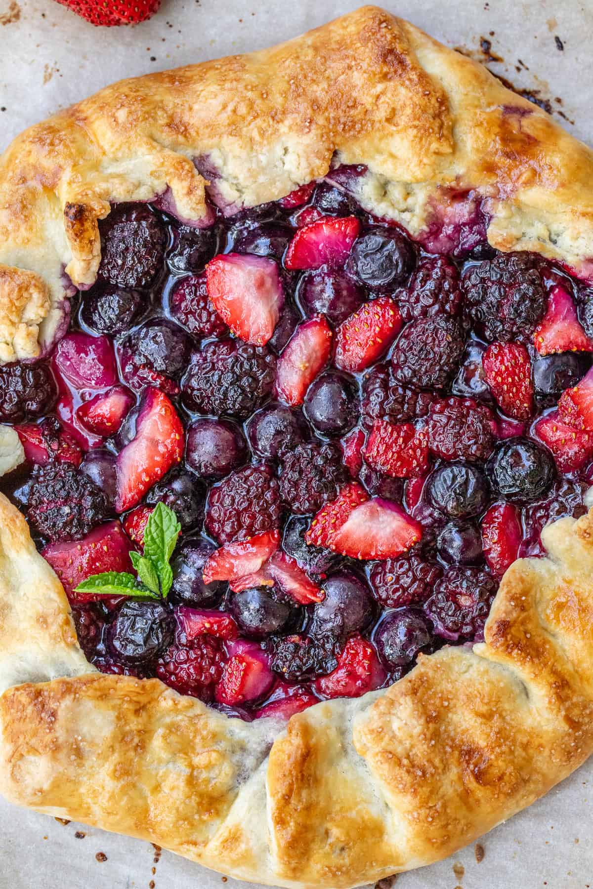 Beautiful Mixed Berry Galette Made with Simple Ingredients A golden crust, loaded with a baked mixed berry filling.