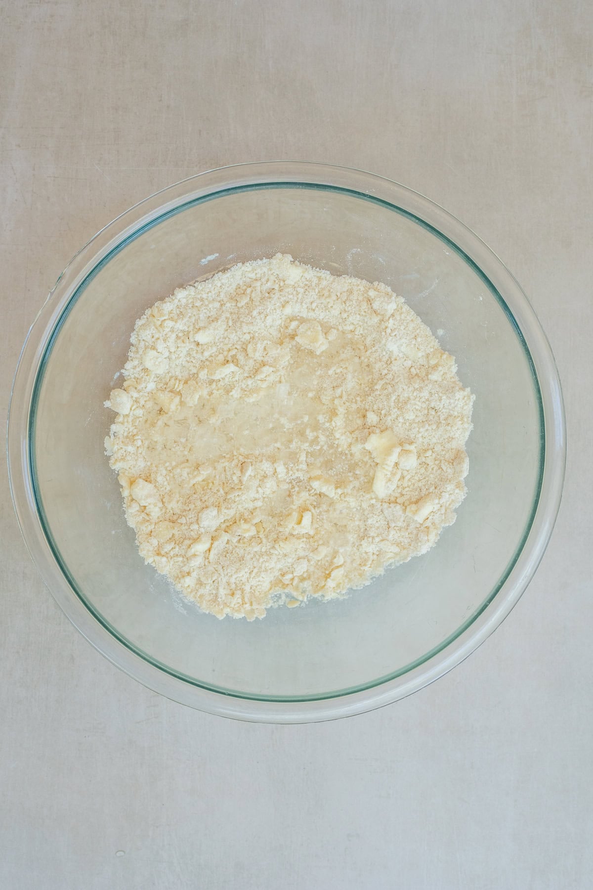 This foolproof galette dough recipe is perfect for beginner bakers and experienced home cooks alike. A glass bowl with the galette dough mixture.