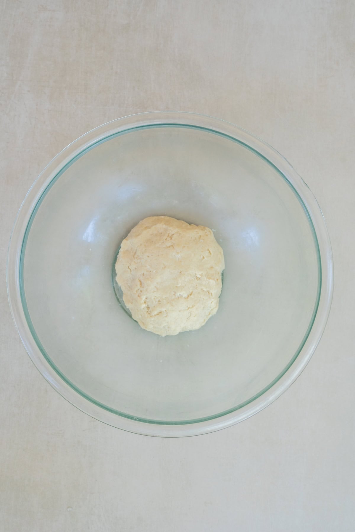 Use this easy galette dough recipe to make sweet fruit galettes or savory vegetable galettes. A bowl with the formed galette dough.