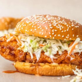 A hot honey fried chicken sandwich topped with crispy coleslaw.
