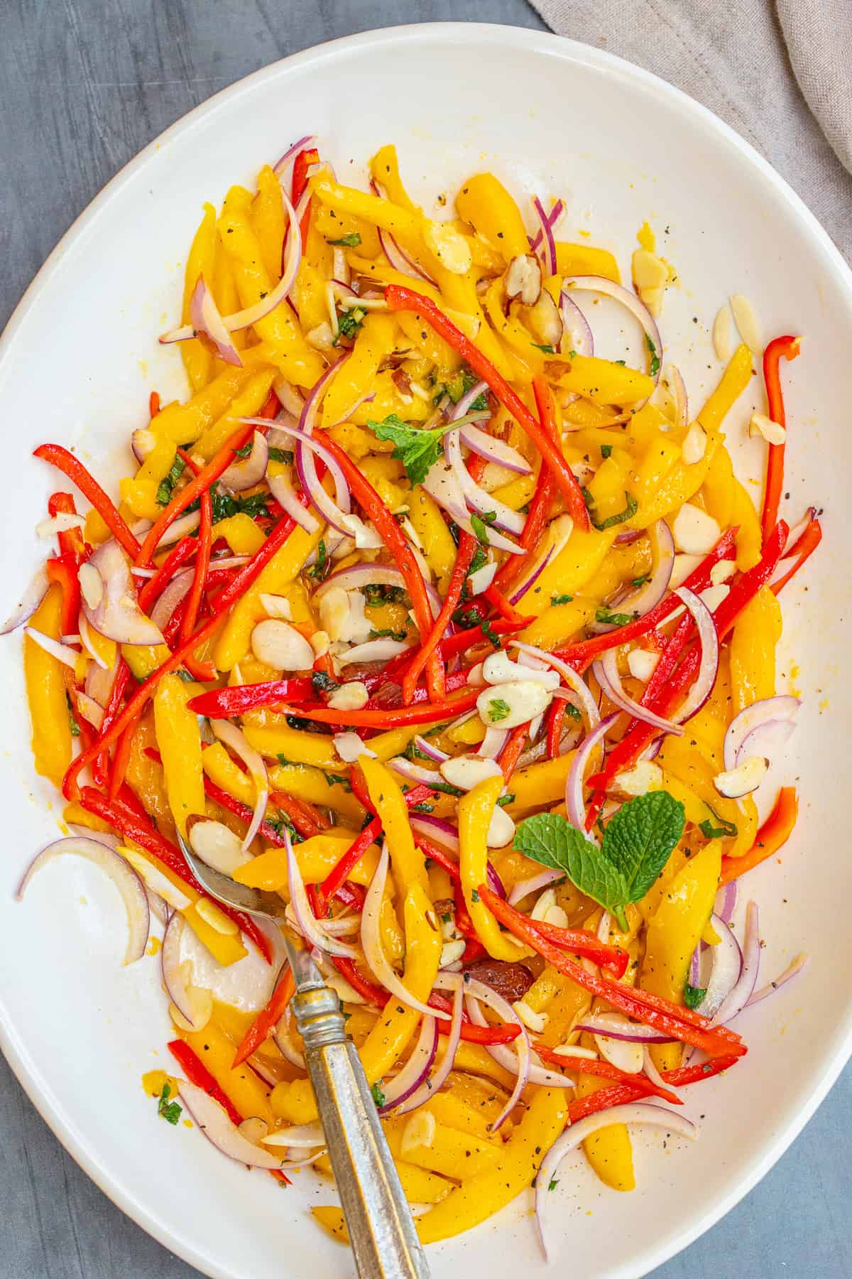 Fresh Mango Salad - Perfect For Any Occasion A large bowl of mango salad garnished with mint.