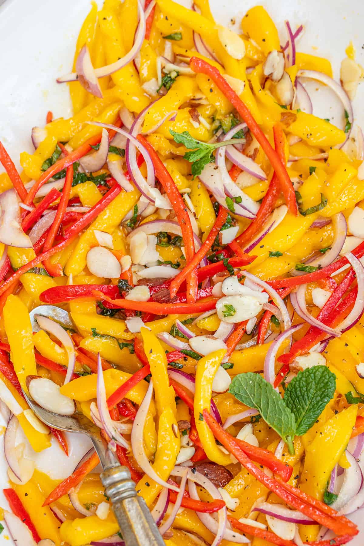 Fresh and Flavorful Mango Salad Recipe The fresh mango salad topped with fresh mint and almonds.