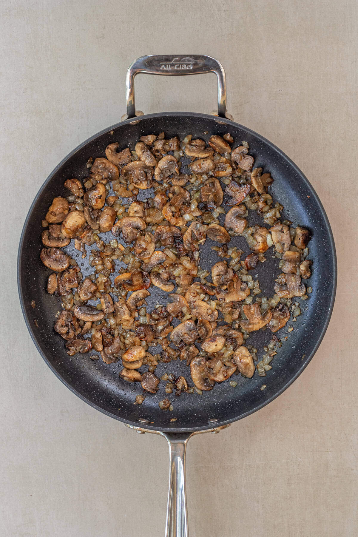 This rustic mushroom galette recipe is perfect for brunch, lunch, dinner, or entertaining guests. A skillet with the cooked mushroom and onion mixture.