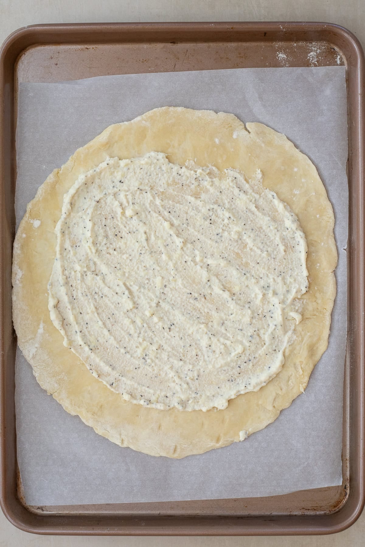 This easy mushroom galette is packed with earthy mushrooms and wrapped in a buttery golden crust. The ricotta mixture spread over the galette pastry dough.