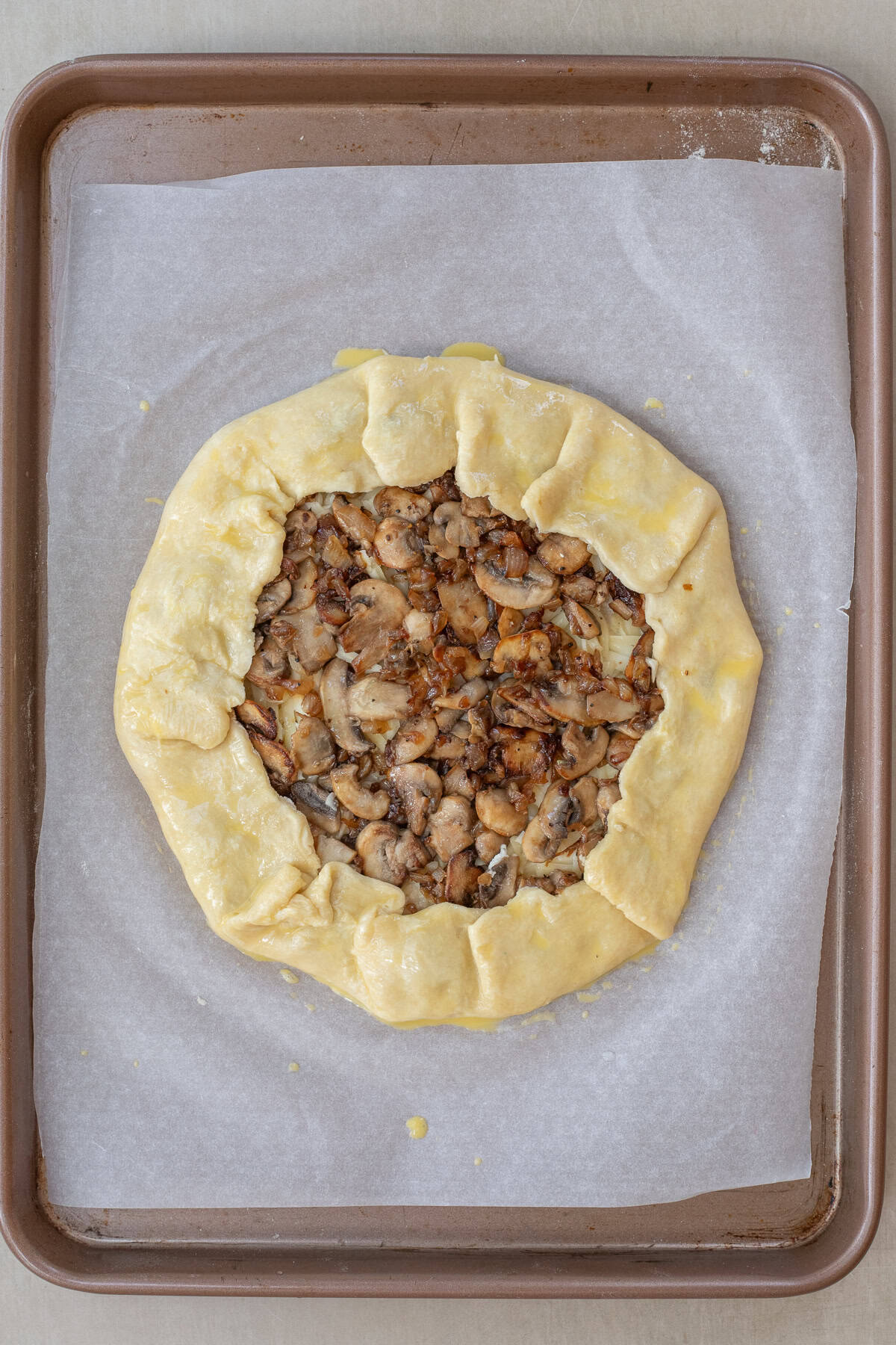 Make this mushroom galette recipe for an elegant yet simple meal that is perfect any time of year. The folded galette filled with mushrooms.