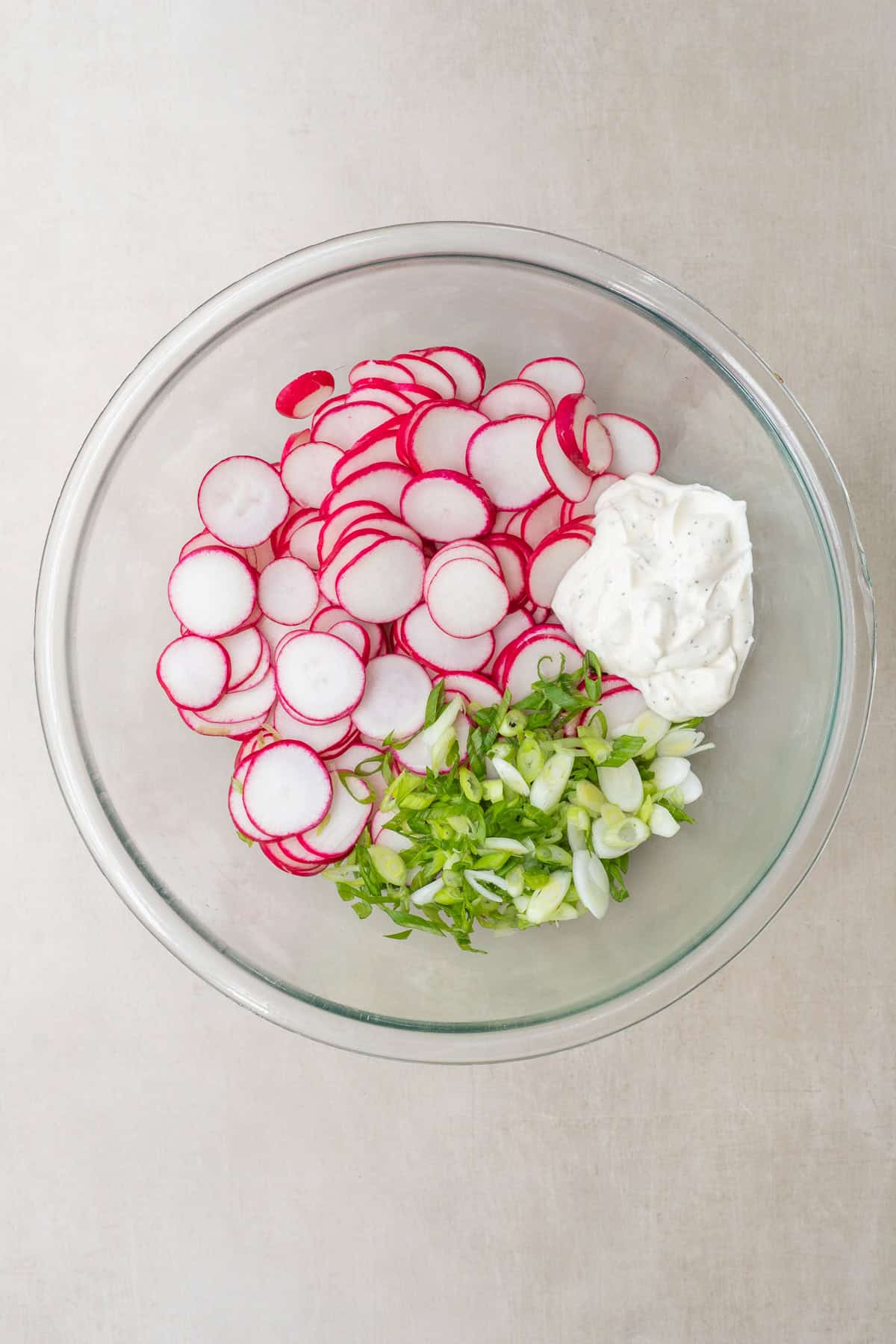 Fresh ingredients come together to make this simple radish salad. A bowl of ingredients for radish salad.