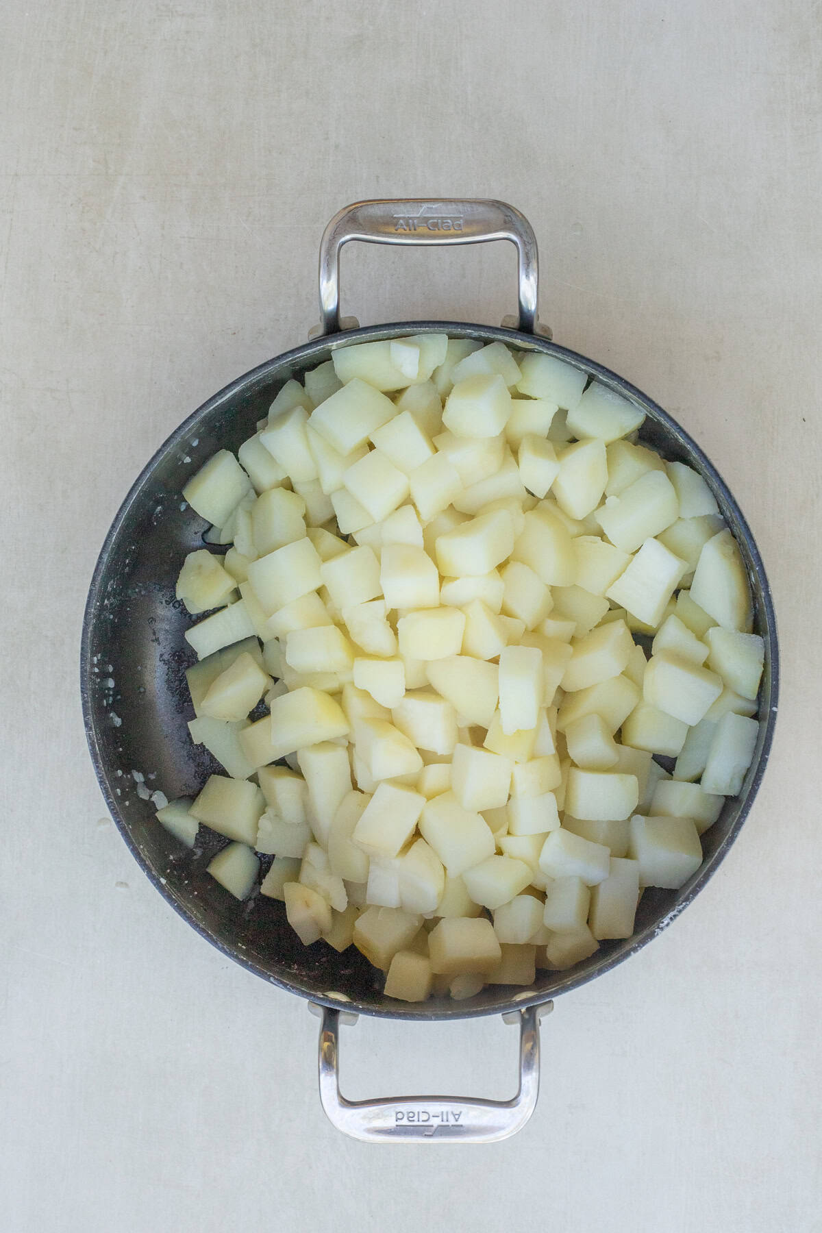Fluffy Mashed Potatoes with Melted Cheese A bowl of cooked and cubed potatoes.